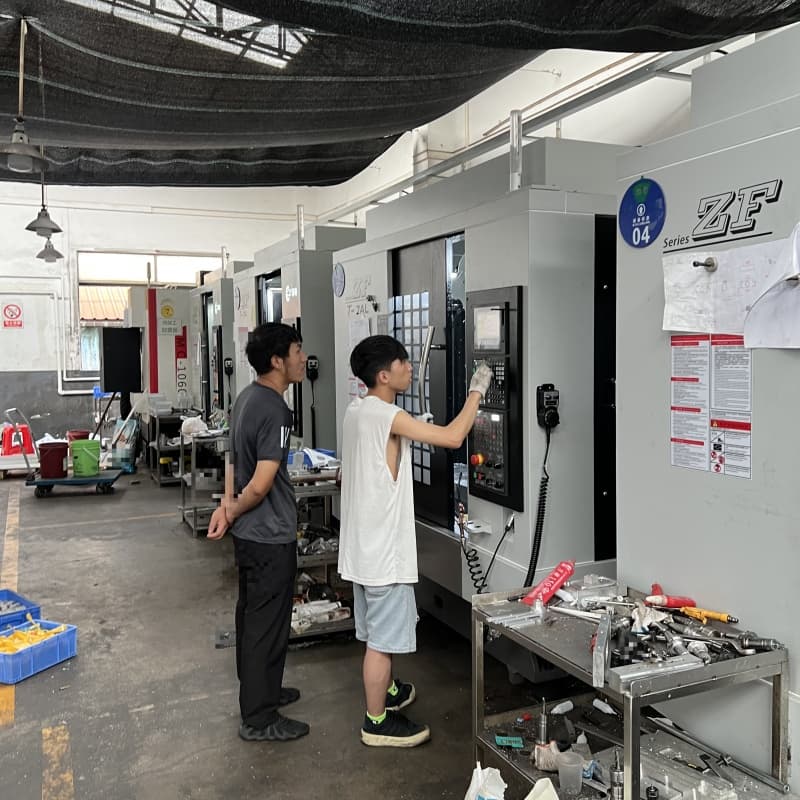 Operator inspecting CNC control panel parameters for tight tolerance manufacturing